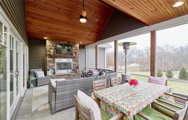 view of patio / terrace with an outdoor living space with a fireplace and ceiling fan