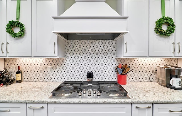 kitchen featuring custom exhaust hood, white cabinetry, and stainless steel gas cooktop