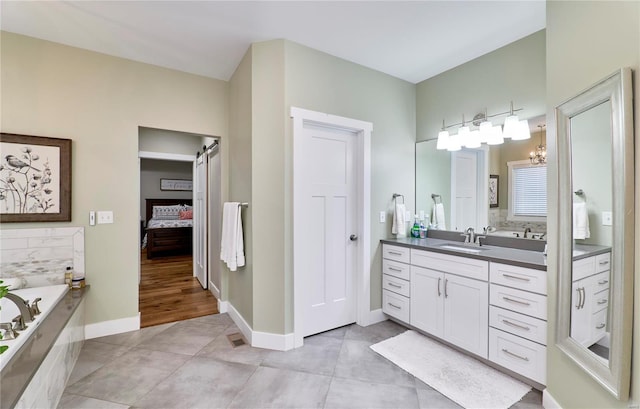 bathroom with vanity, tile patterned flooring, and a washtub