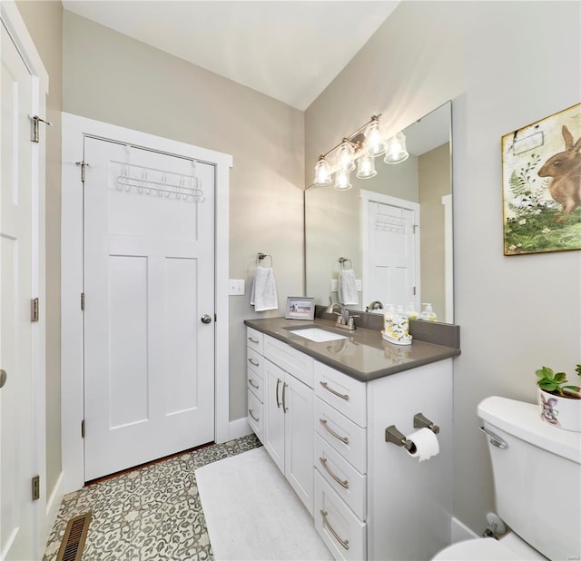 bathroom with vanity and toilet