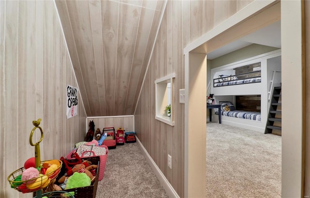 playroom with carpet, wooden ceiling, and wood walls