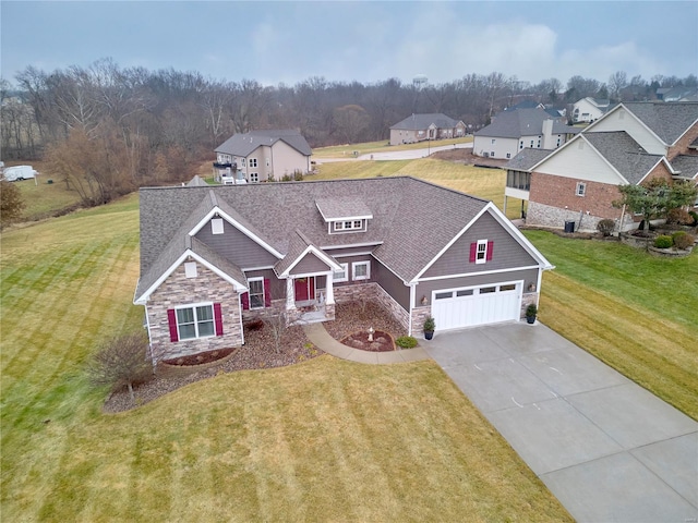 craftsman-style house featuring a garage and a front yard