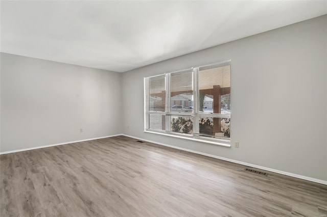 spare room with hardwood / wood-style floors