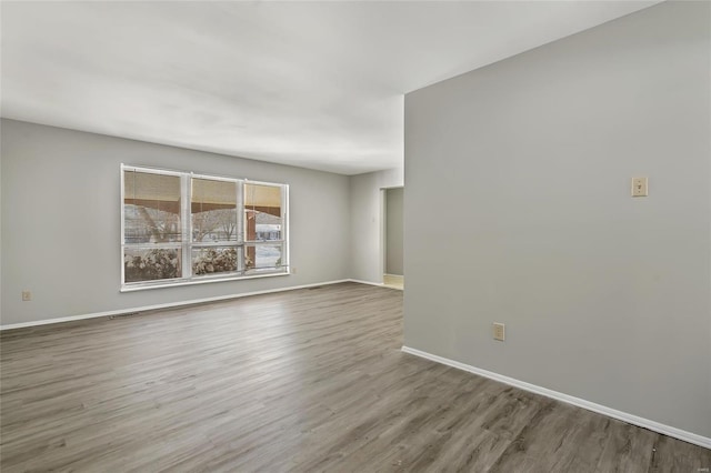 spare room with wood-type flooring