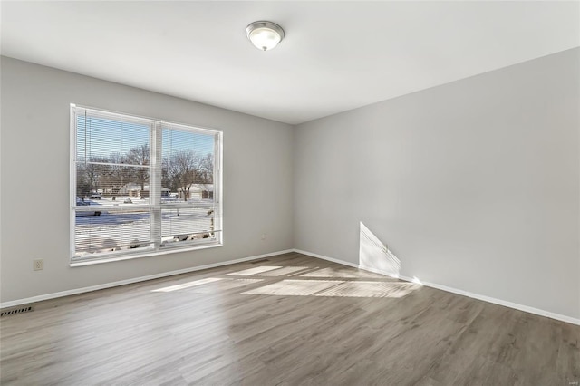 spare room featuring hardwood / wood-style floors