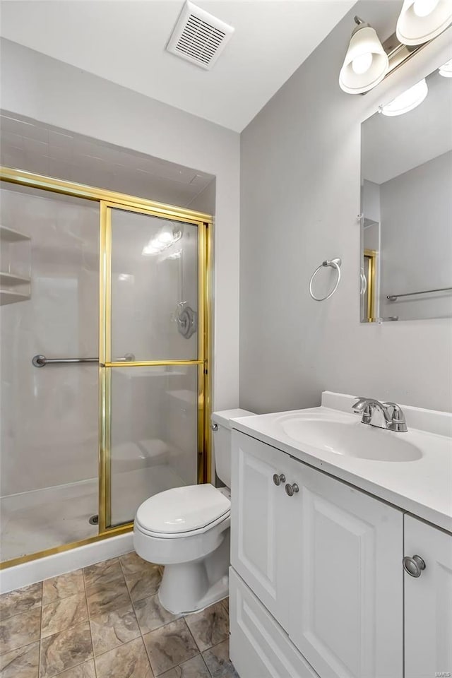 bathroom with vanity, toilet, and a shower with door