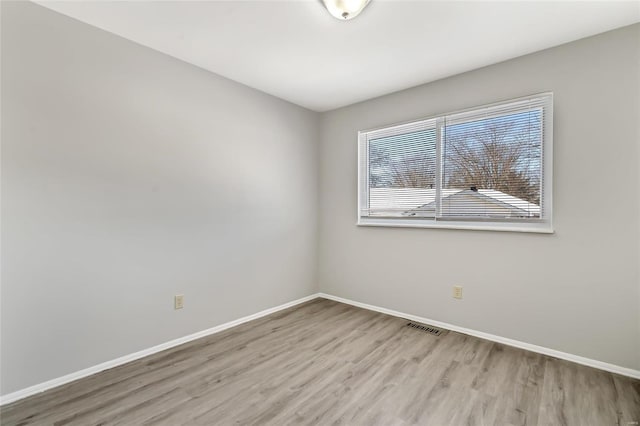 spare room with light wood-type flooring