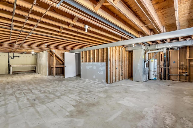 basement featuring heating unit and water heater