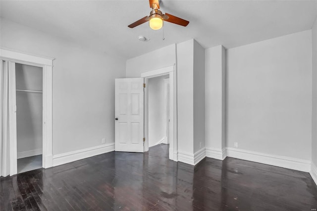 unfurnished bedroom with a closet, ceiling fan, and dark wood-type flooring