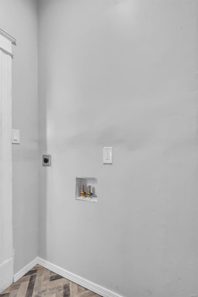 clothes washing area featuring laundry area, hookup for an electric dryer, baseboards, and hookup for a washing machine