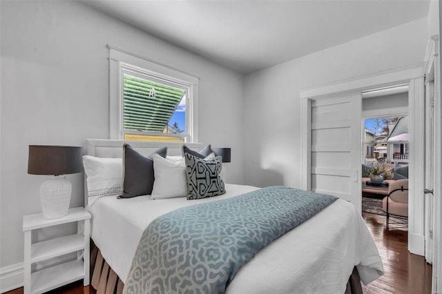 bedroom with dark wood-style flooring
