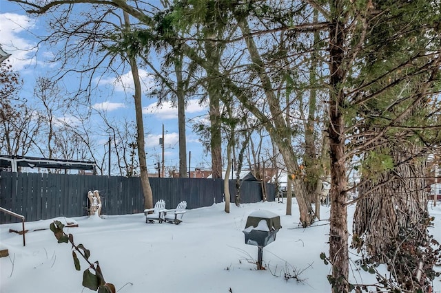 yard covered in snow with fence