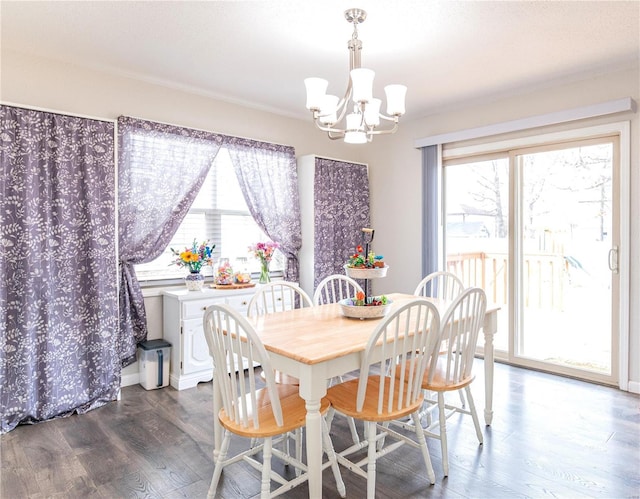 dining room featuring a notable chandelier, dark wood finished floors, and baseboards