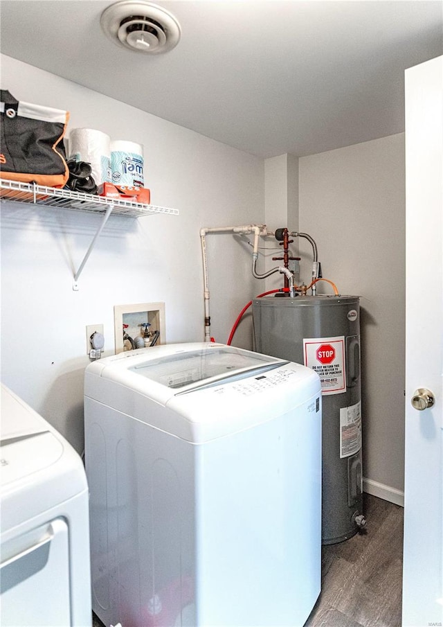 laundry area with laundry area, visible vents, wood finished floors, electric water heater, and washing machine and dryer