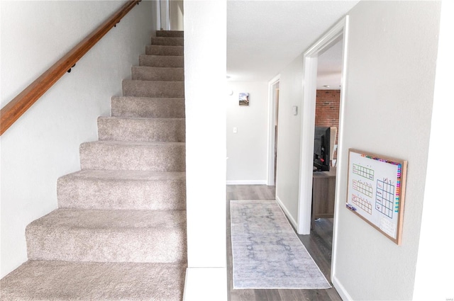 staircase with wood finished floors