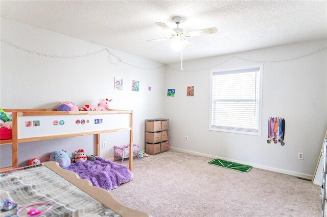 bedroom with ceiling fan, a textured ceiling, baseboards, and carpet flooring