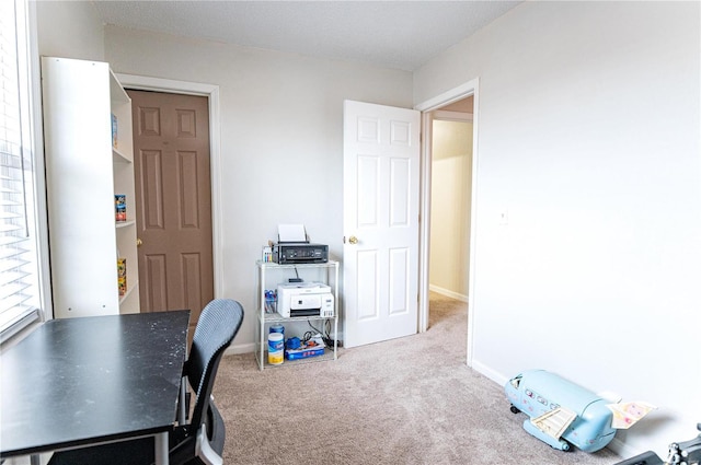 carpeted home office with baseboards