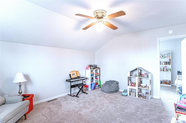 playroom with lofted ceiling, a textured ceiling, carpet, and baseboards