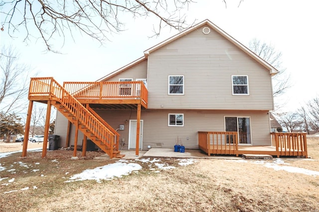 back of house with stairway, a patio, and a wooden deck