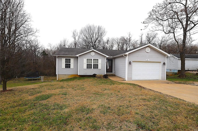 view of front facade featuring a garage, a trampoline, and a front yard