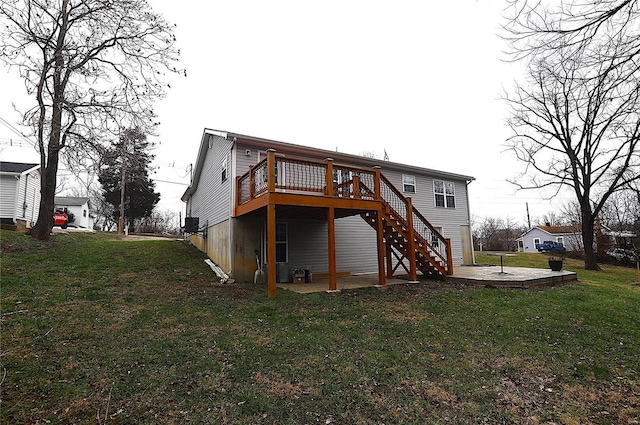 back of house featuring a lawn, a patio area, and a deck