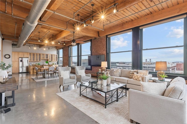 living room featuring beamed ceiling, concrete floors, ceiling fan, and wooden ceiling