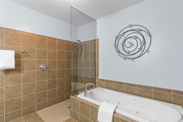 bathroom with tile patterned flooring and separate shower and tub