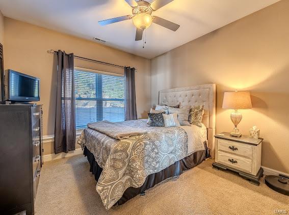 carpeted bedroom with ceiling fan