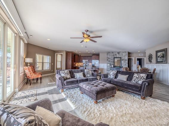 living room with hardwood / wood-style flooring and ceiling fan