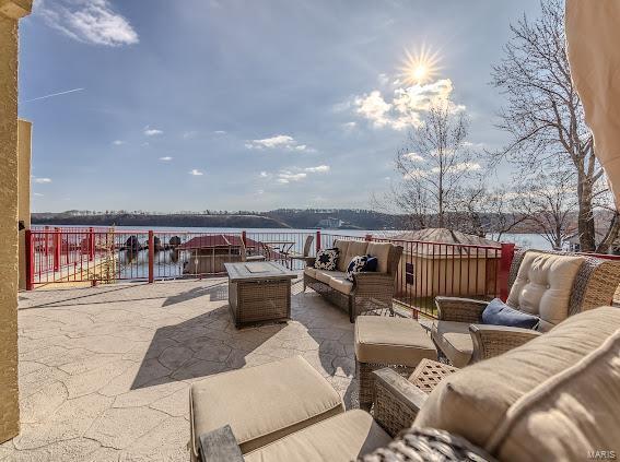 view of patio / terrace with outdoor lounge area and a water view