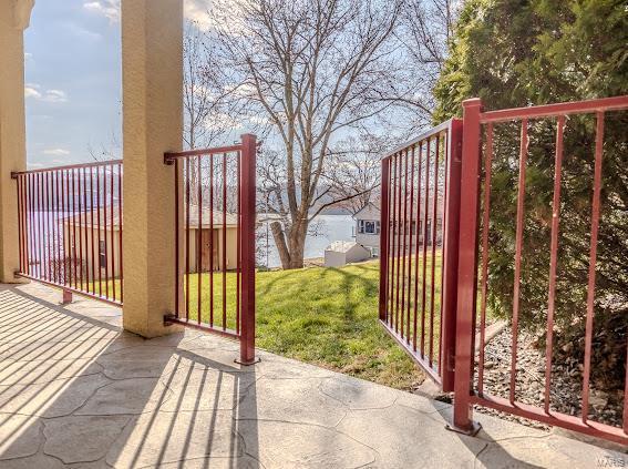 view of gate with a lawn