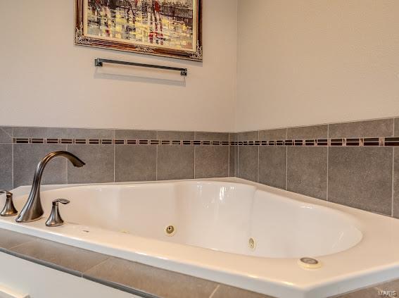 bathroom featuring a relaxing tiled tub