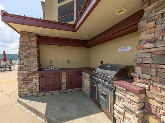 view of patio / terrace featuring an outdoor kitchen and sink