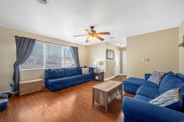 living room featuring ceiling fan and hardwood / wood-style flooring