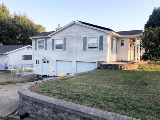 view of front of house with a front lawn and a garage