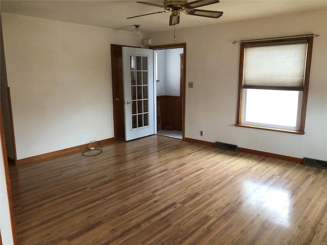 unfurnished room with french doors, hardwood / wood-style flooring, and ceiling fan