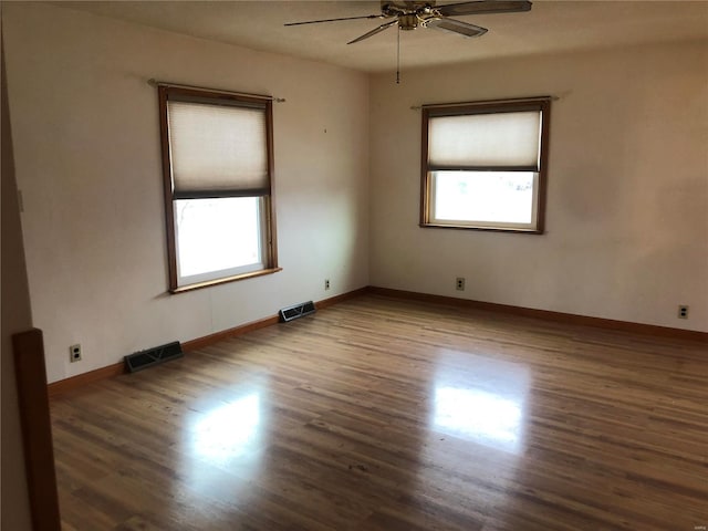 unfurnished room featuring dark hardwood / wood-style floors and ceiling fan