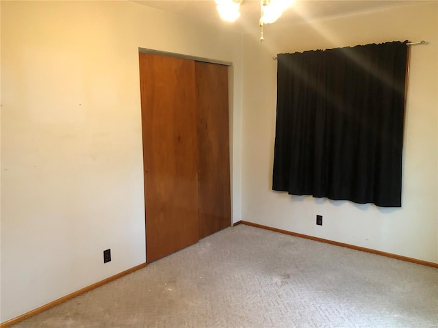 unfurnished bedroom featuring carpet flooring and a closet