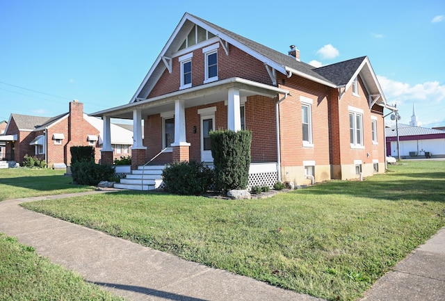 bungalow-style home featuring a porch and a front yard