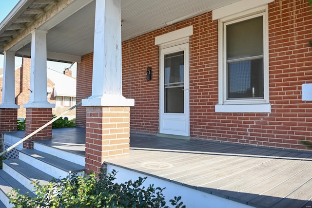 view of exterior entry featuring covered porch