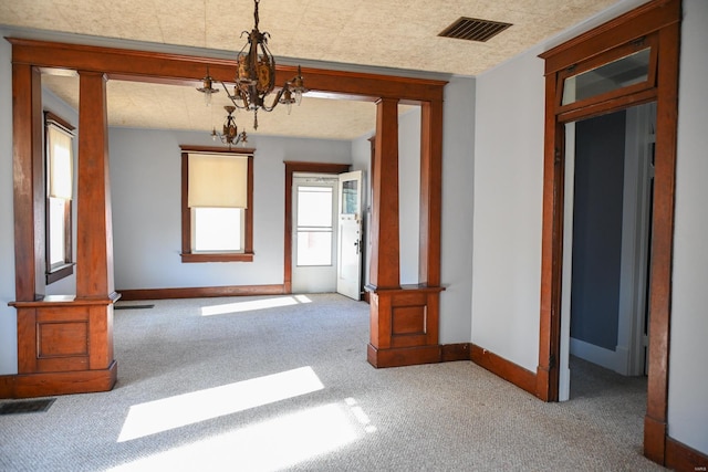 interior space with carpet flooring and a chandelier