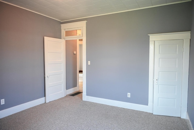 carpeted spare room with crown molding