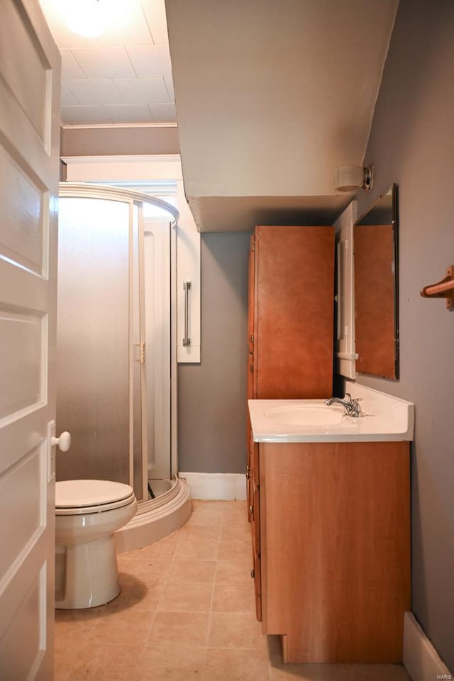 bathroom with a shower with door, vanity, and toilet