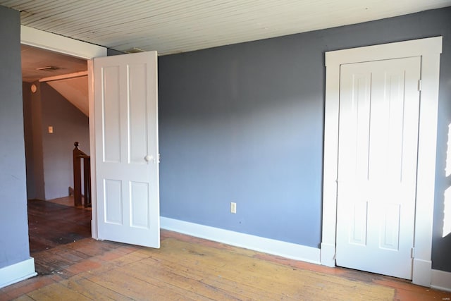 unfurnished bedroom featuring hardwood / wood-style flooring