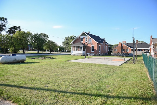 view of yard with basketball hoop