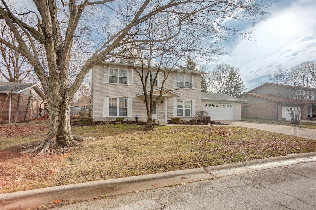 view of front facade with a front yard and a garage