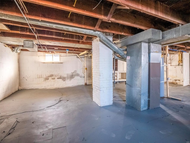 basement with water heater and heating unit