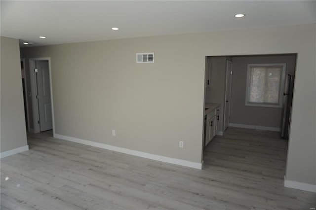 unfurnished room with light wood-type flooring