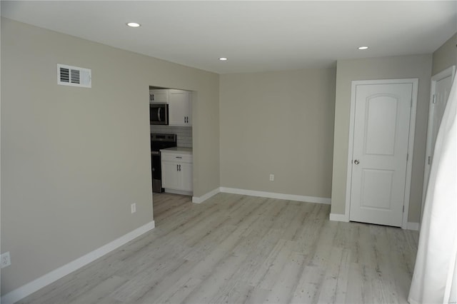 spare room with light wood-type flooring