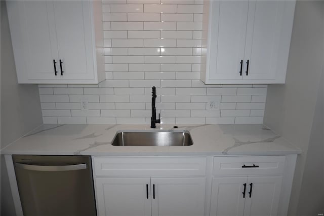 kitchen with backsplash, white cabinetry, and dishwasher